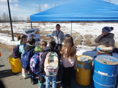 Children listening to Lisa talk about hazardous waste